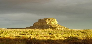 Photo of sun and storm over Fajada Butte